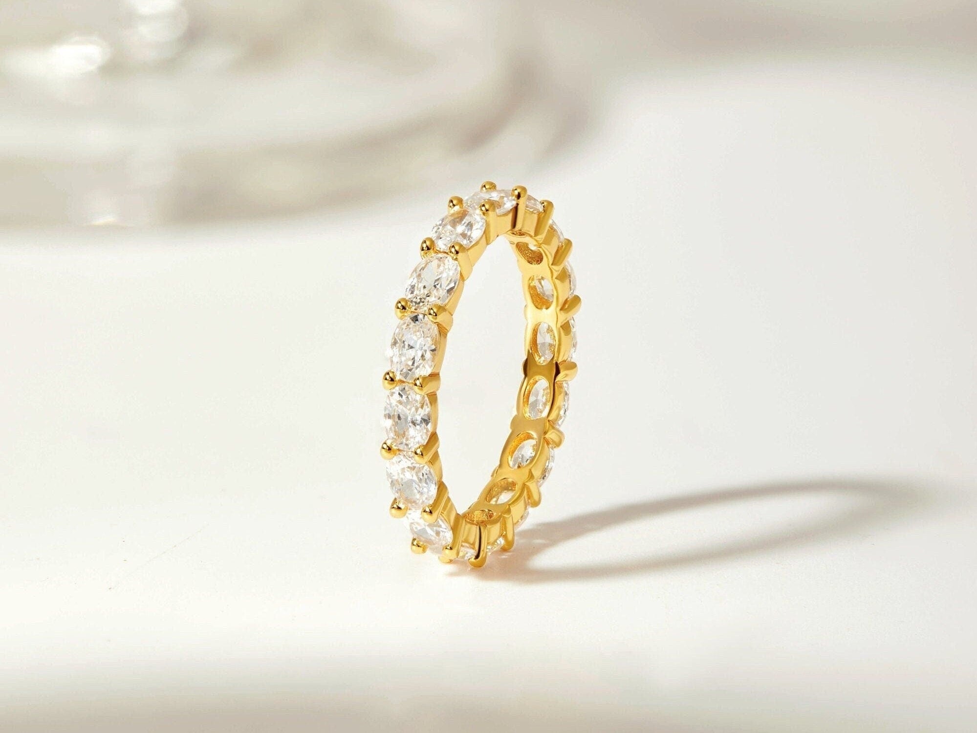 Opulent Oval Cut Gold Eternity Band